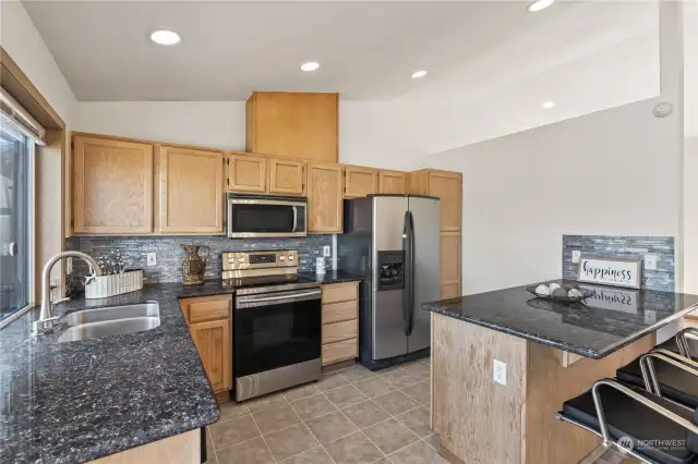 Beautiful kitchen with granite countertops & plenty of room to entertain and host