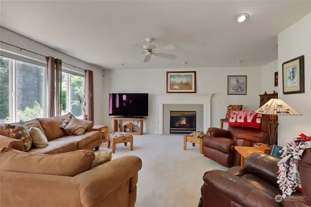 cozy family room with gas fireplace and large windows to take in your gorgeous back yard views