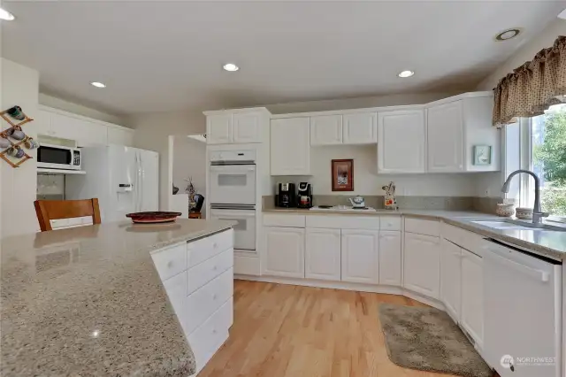 spacious kitchen with breakfast bar, lots of storage and walk in pantry
