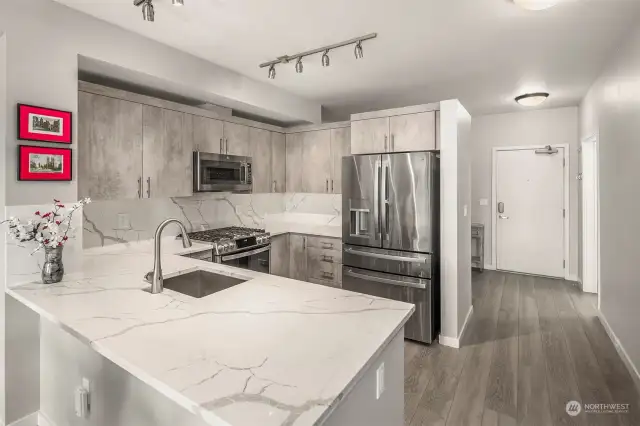 Stainless steel appliances highlight the kitchen and are included in the sale of the home.