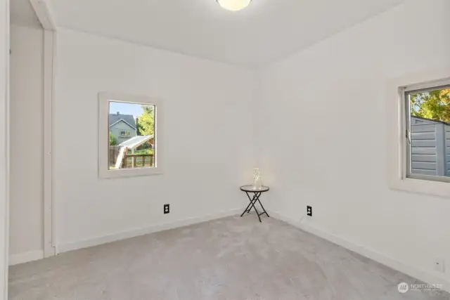 Bedroom with recent carpet and view of the back yard