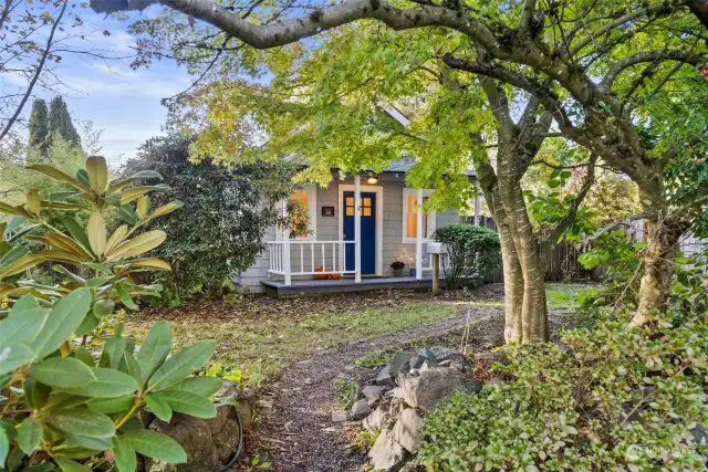 The front of the home is nestled behind this beautiful greenery!