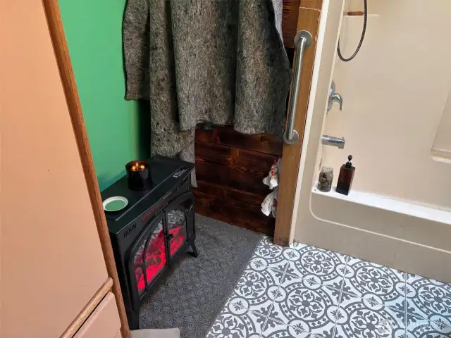 Tub and heater in bathroom.