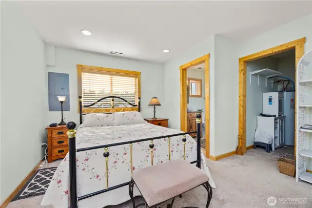 The primary bathroom is to the far right  after the walk in closet which houses the water heater.