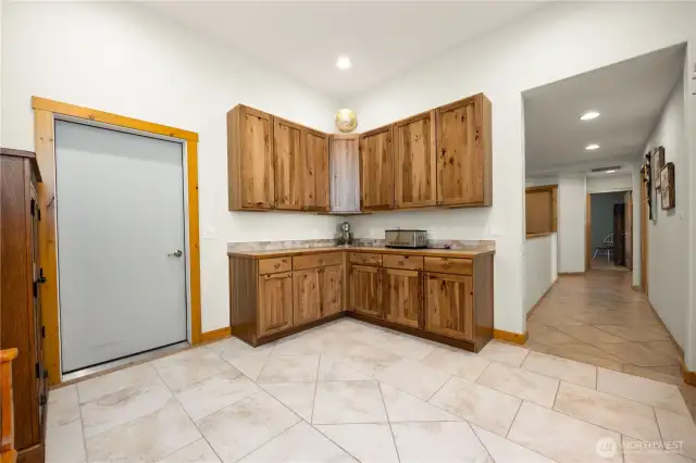 From the bedroom hallway outside of the laundry room is another functional work area for a kitchenette or crafts.