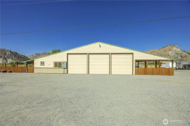 A view from outside, the south side of the structure with the entrance to the left/west and the four bay carport to the right/east.
