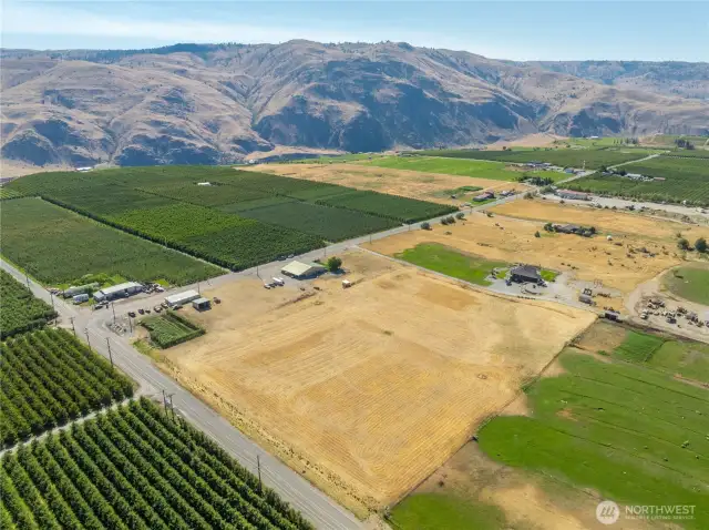 A drone's eye view of this level acreage.  This captures not only the residence but the large shop, hay shed and a small patch of corn on the left corner of the property.