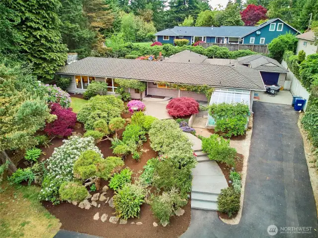 Private drive leads to this sprawling mid-century home with Lot A beach rights.