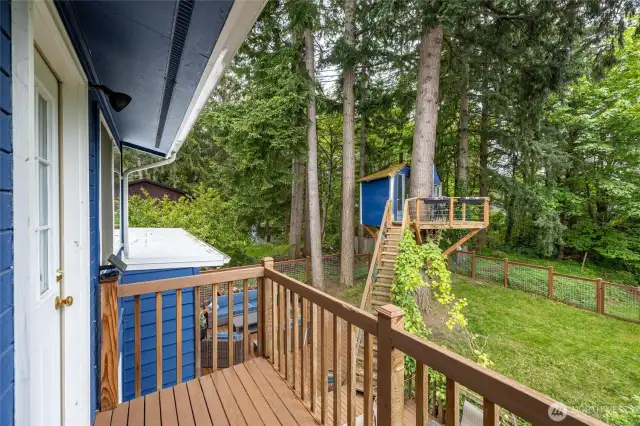 The primary bedroom has a small deck overlooking the awesome backyard.