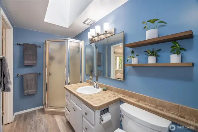 This 3/4 bathroom is accessible from the primary bedroom and the hallway.