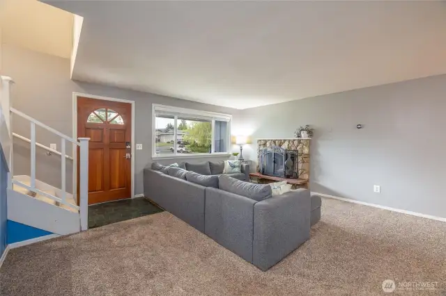 Another view of the living room and front door