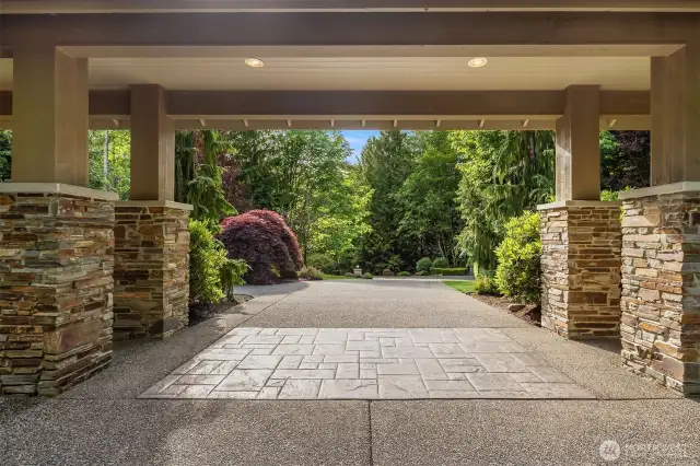 View of driveway leading to garages and the porte-cochere.
