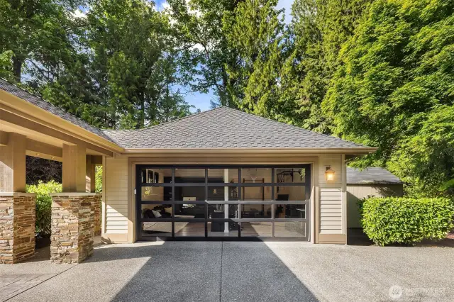 Detached garage with lighted door in the down position.