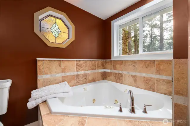 Jetted tub in primary bathroom for ultimate relaxation.