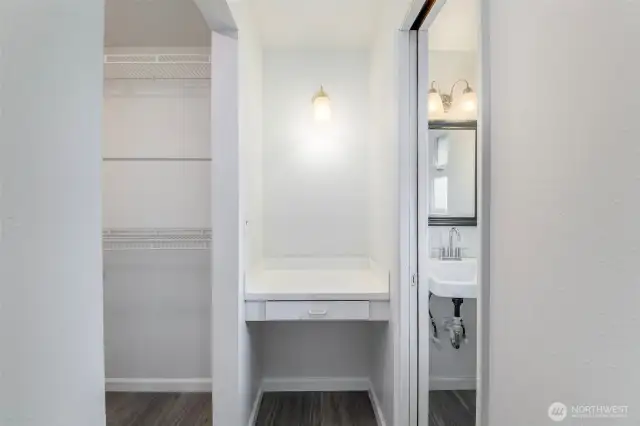 Walk in closet, vanity area and half bath.