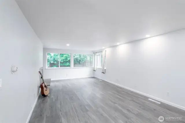 Living room with recessed lighting and fireplace.