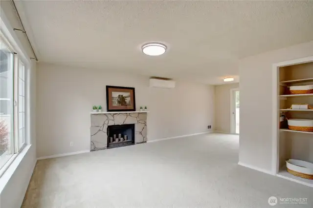 Bright Living Room with fresh interior paint, new carpet, and ductless heat pump for year-round comfort,