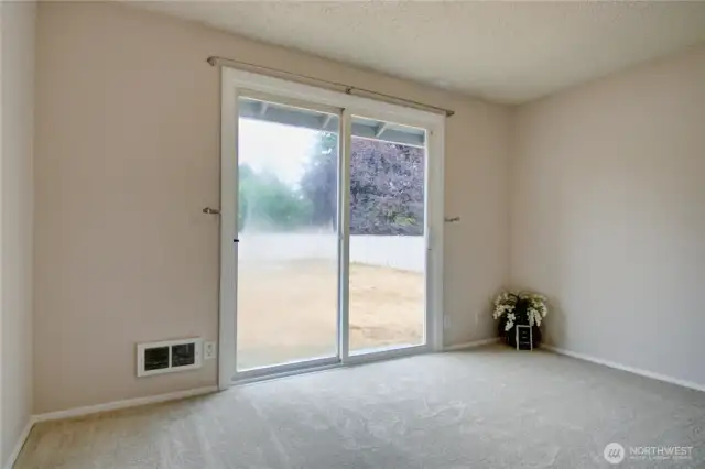 Primary bedroom with private slider access to backyard - perfect for morning coffee or evening breezes