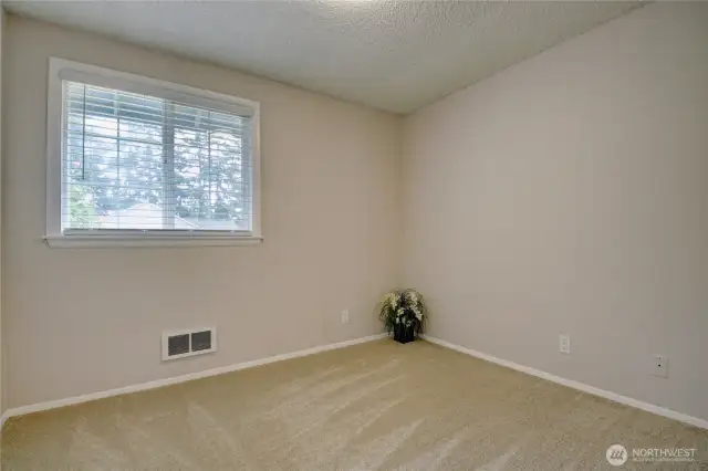 Bedroom 2 with fresh paint, new doors, and window blinds.