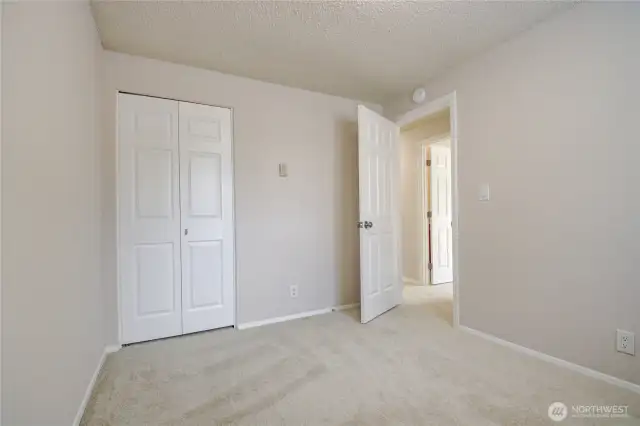 Bedroom 3 with fresh paint, new doors, and window blinds