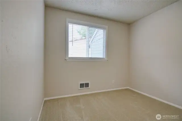 Bedroom 3 with fresh paint, new doors, and window blinds