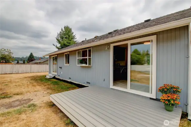 New composite deck off dining room overlooks private backyard