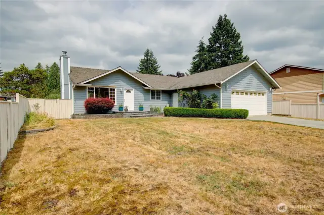Pretty front yard with roses and irises adds curb appeal to this move-in ready 3 bedroom home