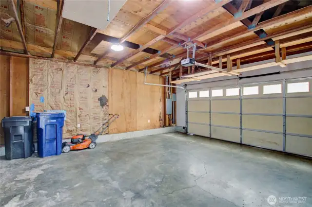 Good size two car garage with built-in shelving and pull-down ladder to overhead storage - room for tools, toys, and more!