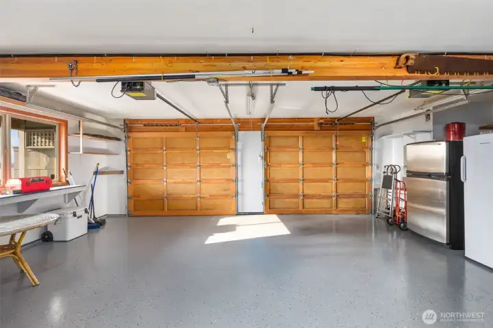 Incredibly large garage with storage space and epoxy floor.