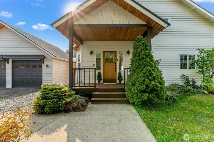 Covered front porch with warm wood detailing and inviting entry Covered front porch with warm wood detailing and inviting entry