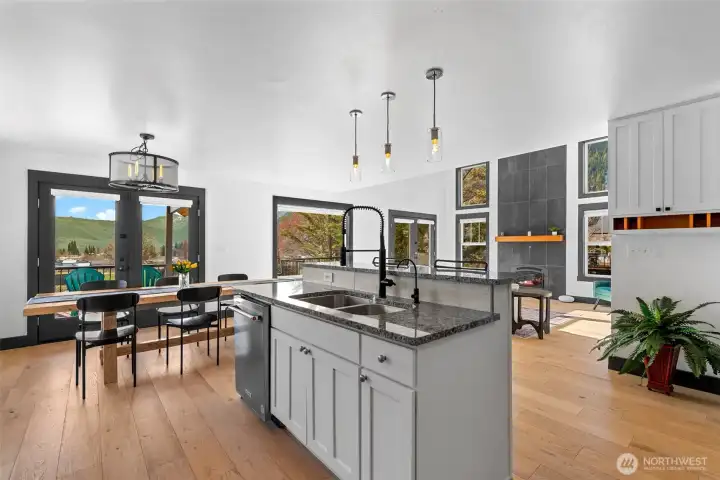 Well-appointed kitchen with granite island, pendant lighting, and seamless flow to dining and living spaces