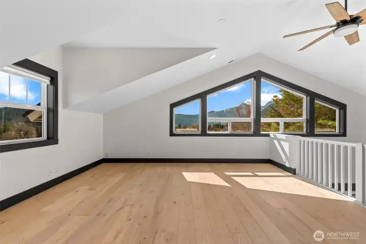 Versatile loft space with vaulted ceilings, natural light,