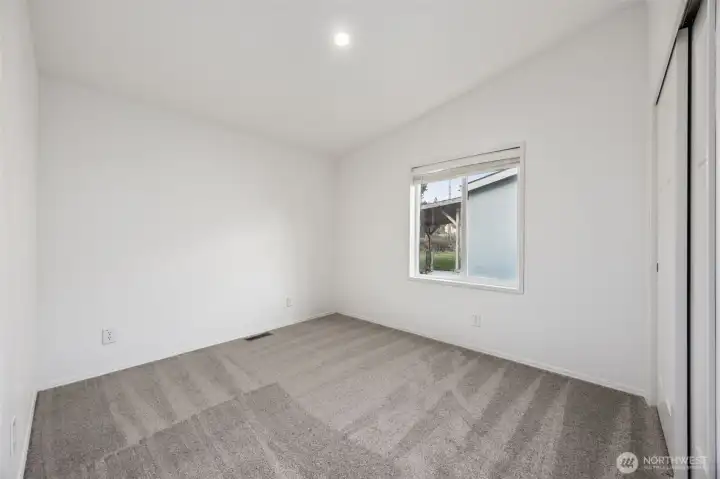 Bedroom #3 is giving strong supporting character energy. Vaulted ceiling, check. Soft mushroom carpet, check. Recessed lighting and privacy blinds, already handled. The closet is sized for real life, and the white walls keep the space feeling crisp and contemporary. If this room is for guests, you’ll be happy to know just 7 minutes away in Tenino, you can find Scatter Creek Brewery and Winery, Tenino Farmer’s Market and Sandstone Distillery, Whitewood Cider Mill, as well as a variety of eateries and other attractions.