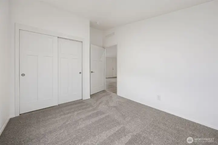 The closet view of bedroom #3.  It’s the kind of room that quietly works no matter how you decide to use it, and located right next to Bedroom #2 and the full main bathroom. Totally separate from the primary suite located on the entire other side of the home.