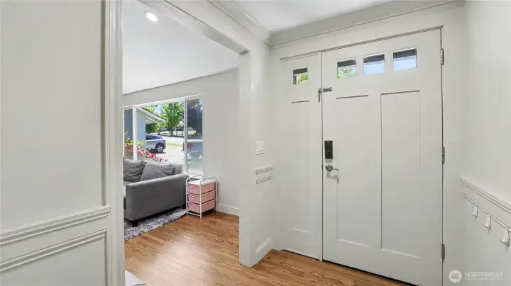 The entry opens onto hardwood floors on the main level.