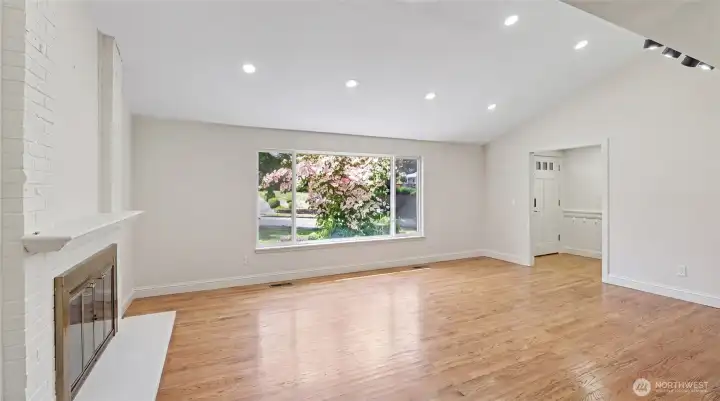 A large picture window showcases the outdoors.