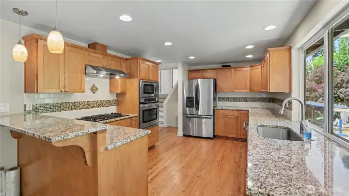 Stainless steel appliances provide modern convenience with a gas cooktop for precision cooking.