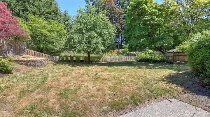 Fully fenced backyard offers privacy and security.