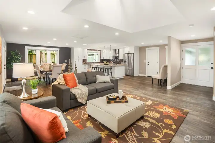 Living room with built-in cabinetry, gas fireplace, wired for surround sound and massive skylight and a Solatube.