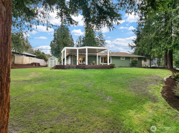 A view from the back of the home highlights the spacious 12,574 square foot lot.  Plenty of room for catch, fetch, and the yard space is equipped with invisible fencing.