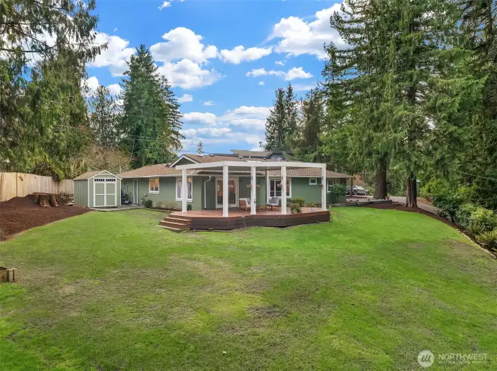 A view from the back of the home highlights the spacious 12,574 square foot lot.  Plenty of room for catch, fetch, and the yard space is equipped with invisible fencing.