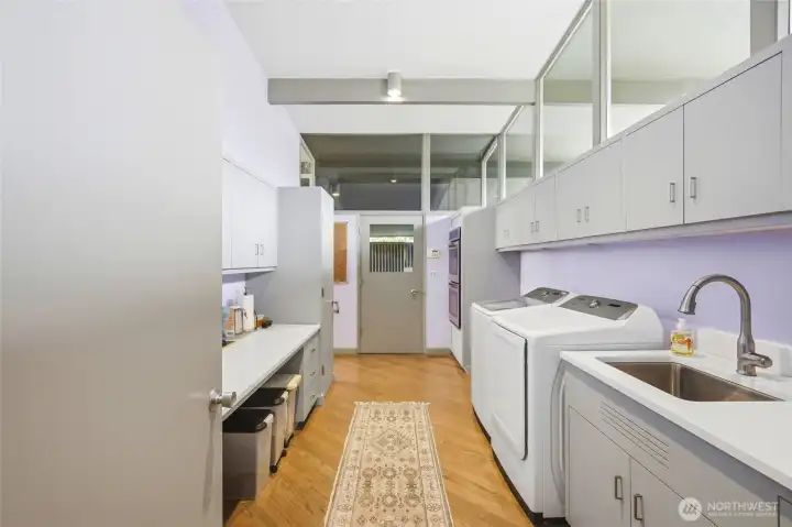 Kitchen looking back at utility room that has an enterance from the garage on the right side (when facing the home).