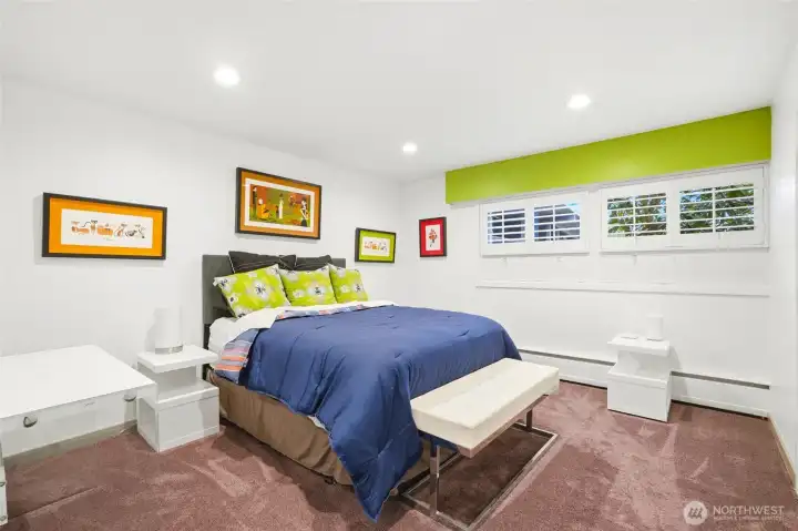 This bedroom looks out to front of house and uses it's own adjacent bathroom.