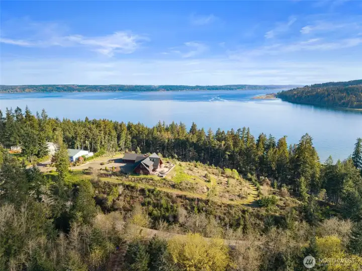 Perched high on the hill of your 5 acre sanctuary with the Hood Canal and Olympic Mountains framing your private retreat.