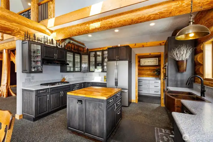A Kitchen for the most discerning chef.  Gorgeous hammered copper sink, stunning cabinets and custom made, unique decorative iron crown accents set this space apart from anything you have ever experienced.