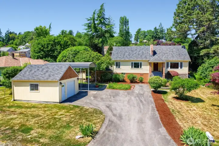 Positioned on a cute road adorned with one-of-a-kind homes- when houses were built to have character. This property offers several different areas or, "outdoor rooms," and ample parking options. You can even look down the street and see the water at Phinney Bay