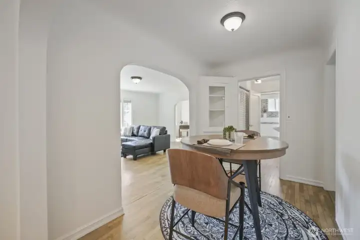 Formal dining off kitchen with hardwood flooring and built-in china cabinet