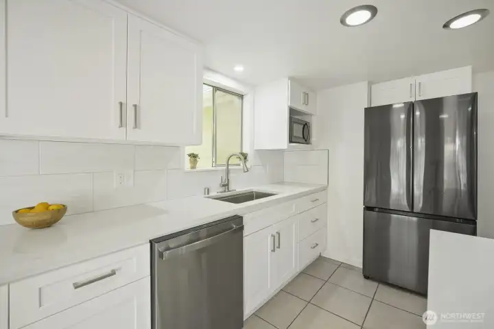 Stainless appliances, soft closing cabinets, deep stainless sink with telescoping faucet & side by side refrigerator with pull out freezer drawer