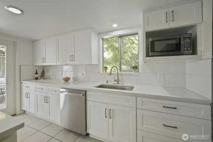 Mostly everything in the kitchen is new! Ample cabinets extend all the way to the ceiling, slab countertops & tiled backsplash for a luxurious look and easy cleaning