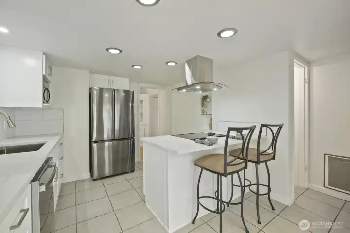 Another view of the kitchen- formal dining on one side (middle of photo), stair access to lower level (right side of photo) and non pictured side is an updated French door that leads to the back patio area.